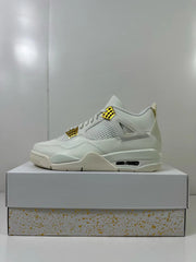 Side view of a white high-top Jordan 4 sneaker with gold-tone lace hardware and a visible air window.