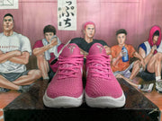 Front view of pink basketball sneakers with textured uppers, pink laces, white midsoles, and visible Nike branding.
