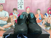 Front view of black Nike LeBron 12 basketball shoes with blue tongue details.