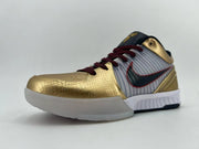 Low side angle showing the gold toe, striped side panel, and white outsole.