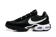 Side view of a black Nike sneaker with a white Swoosh, visible cushioning windows and a lugged outsole.