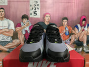 Front view of Nike sneakers showing black laces, haze blue uppers, bright green Swooshes and black toe caps.