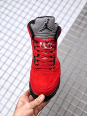 Front view showing the red laces, grey tongue, black eyelets, and Jumpman branding.