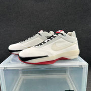 Angled view of the pair displaying the white upper, black laces, red accents, and side Swoosh.