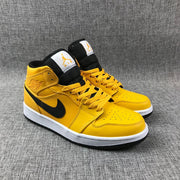 Three-quarter front view of the yellow and black sneaker pair.