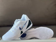 Nike Kobe 9 sneaker shown with its outsole exposed, displaying the white patterned tread and purple heel detail.