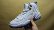 Side view of one white and blue high-top sneaker held in hand.