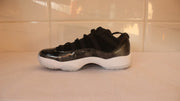 Outer side profile of the black low-top sneaker with a white sole.