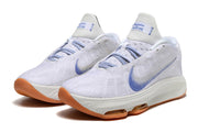 Pair of white Nike GT Hustle 3 shoes with blue Swoosh details and gum-colored outsole.
