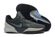 Gray Jordan sneakers displayed from the side with one shoe showing the patterned outsole.