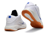 White and blue Nike GT Hustle 3 shoes shown from heel and outsole angles with gum-colored outsole accents.