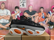 Side view of a black Nike sneaker showing the patterned side panel, orange Swoosh detail, and white outsole.