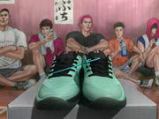 Front view of mint green Nike sneakers with black laces and black toe accents.
