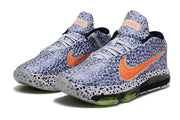 Pair of blue-patterned Nike GT Hustle 3 shoes with orange Swoosh details.