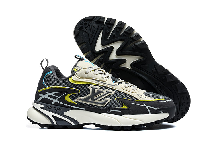 Black and grey chunky sneakers with cream, yellow, and blue accents, shown from the side with the outsole visible.