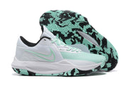 White and mint basketball shoe with a black-and-mint patterned outsole.