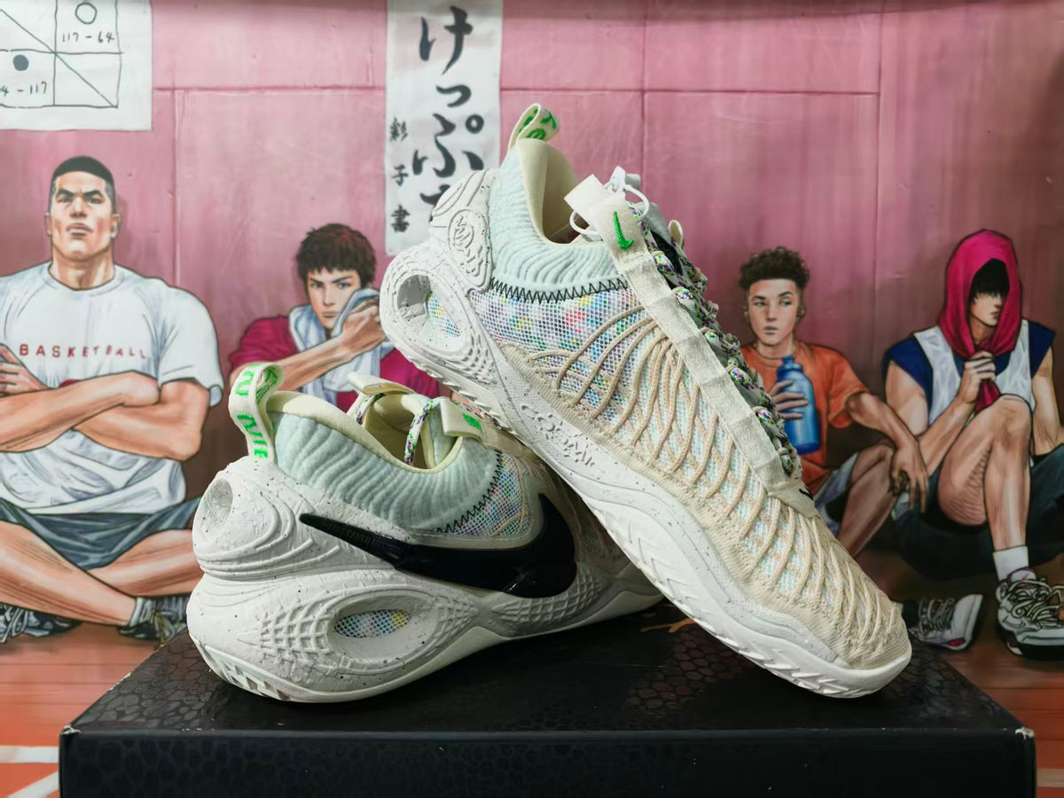 Pair of off-white Nike basketball sneakers displayed at an angle, showing the black side Swoosh, textured upper, and multicolor laces.