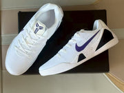 Top and side view of the white and purple Nike Kobe 9 sneakers with lace-up closure and Kobe tongue logos.