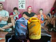 Pair of yellow-and-blue mismatch basketball sneakers shown from the heel, with textured uppers and contrasting branding.