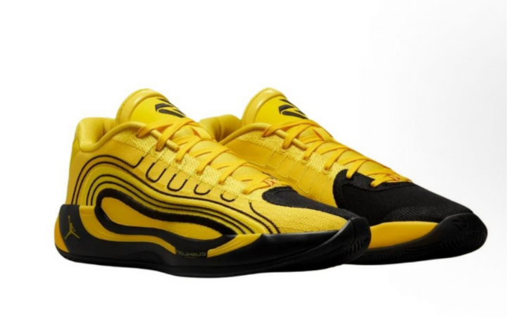 Pair of yellow and black Jordan low-top basketball sneakers with layered side detailing and black outsoles.