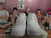 Front view of white Nike low-top sneakers showing the laces, perforated toe boxes, and tongue branding.