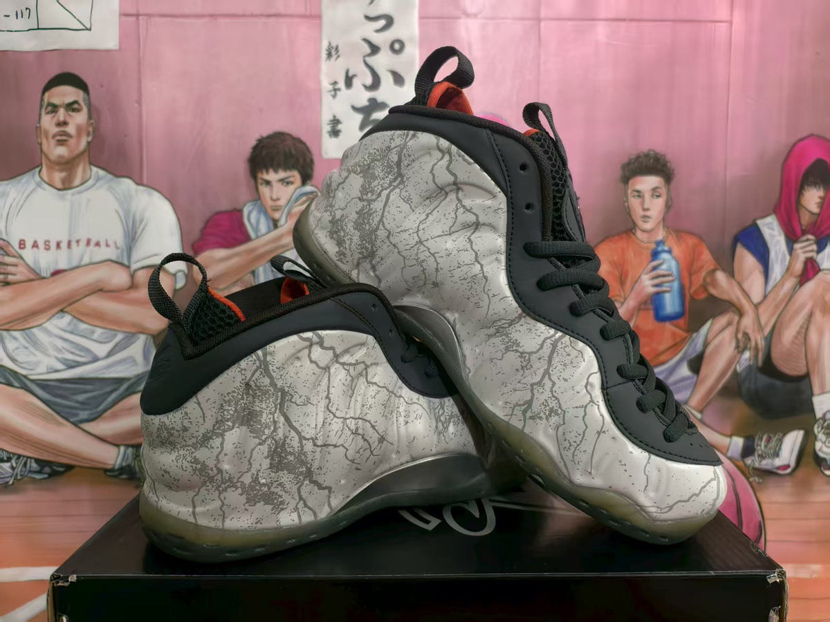 Pair of high-top sneakers showing the white and gray cracked-pattern upper, black overlays, and translucent outsole.