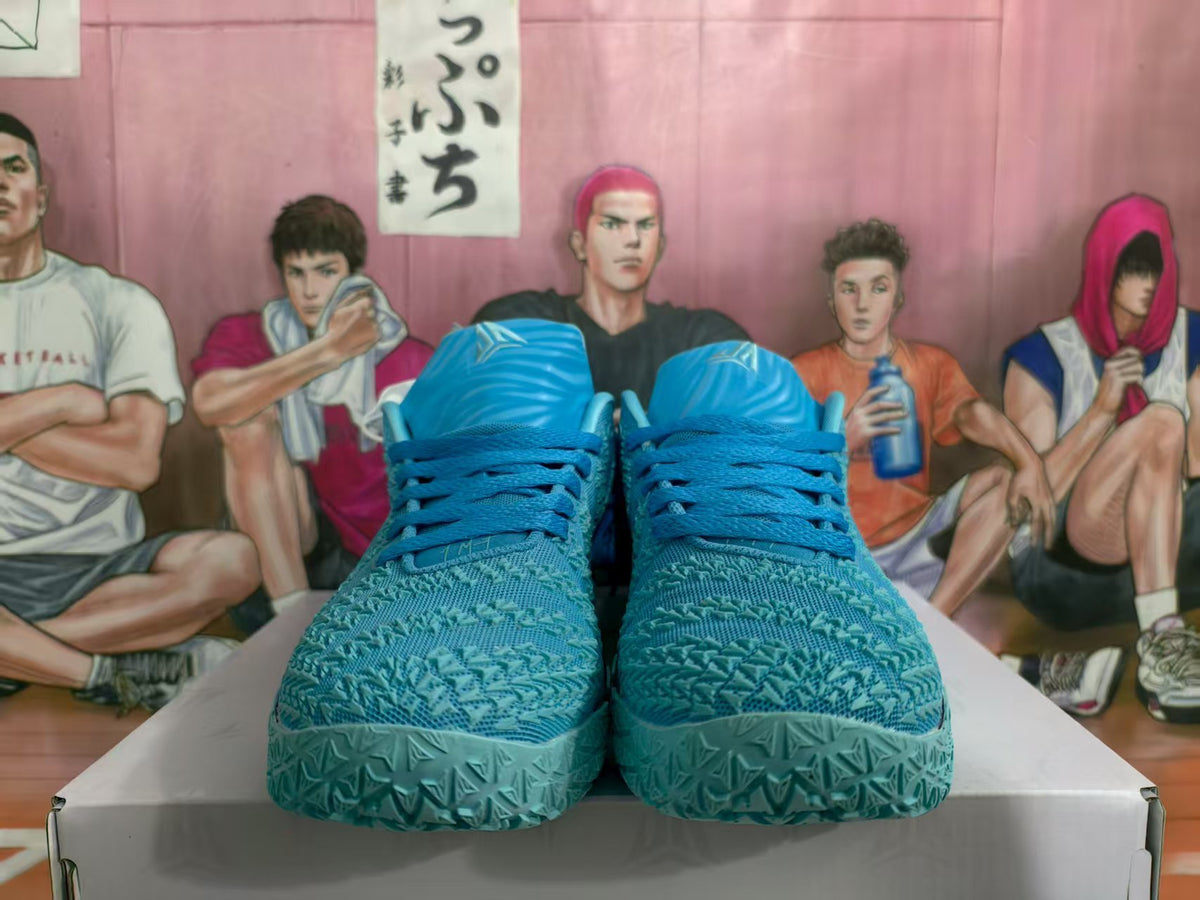 Front view of blue Nike basketball sneakers with patterned uppers and light-blue soles.