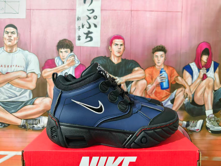 Side view of black and blue Nike Air Destrukt high-top sneakers with white Swoosh and sculpted black soles.