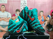 Angled view of the green Nike sneakers showing the side branding, textured outsole, and layered construction.