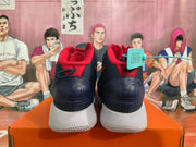 Rear view of navy and red Nike basketball shoes with white soles