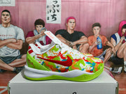 Side view of one colorful Nike basketball sneaker showing the red Swoosh, multicolor patterned upper, white midsole, and green outsole.