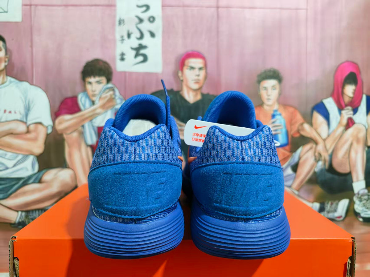 Rear view of blue Nike sneakers showing patterned collars and ribbed soles.