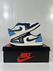 Two low-top sneakers displayed together on a Jordan shoebox, showing the side panels and rubber outsoles.