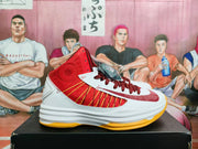 Side view of a red and white high-top basketball shoe with a visible swoosh, red panel detailing, white layered midsole, and yellow outsole.