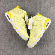 Side view of both sneakers highlighting the perforated panels, layered overlays, white midsoles, and yellow accents.
