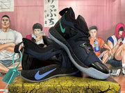 Angled view of black Nike basketball sneakers with blue and pink accent details, speckled midsoles and translucent outsoles.