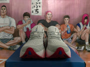 Front view of the Brooks shoes showing the laces, perforated-looking uppers, and red outsole details