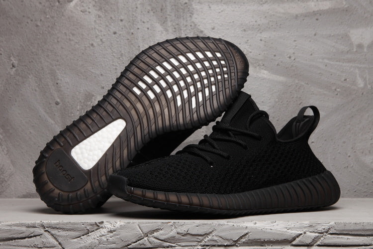 Black low-top sneaker shown from the side and outsole, highlighting the textured upper and ribbed dark sole.