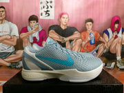 Side profile of a grey and blue Nike basketball shoe with a blue side logo