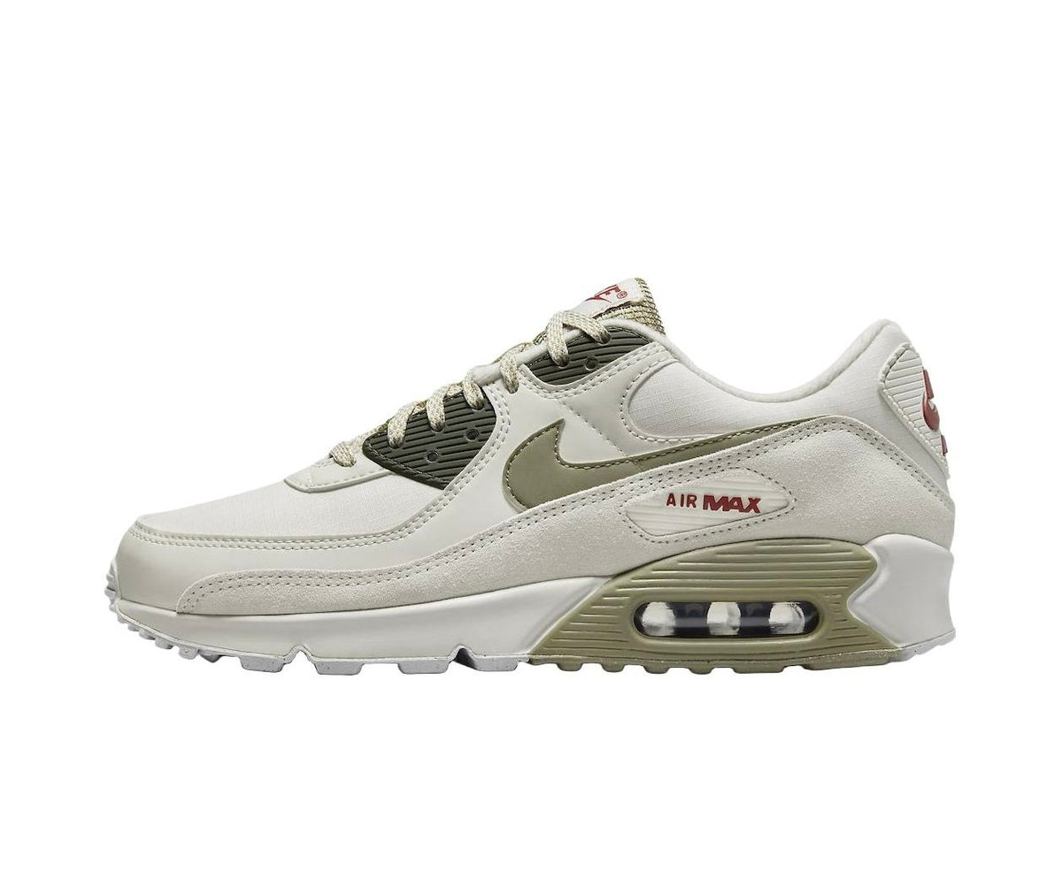 Side view of a light neutral Nike Air Max sneaker with olive-toned details, burgundy accents, and a visible heel Air unit.