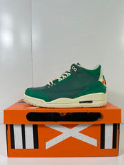 Side profile of a green and off-white high-top sneaker with orange heel detailing.