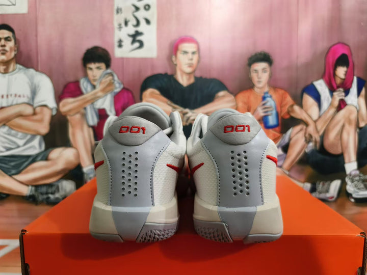 Rear view of white and red Nike basketball shoes with gray heel panels