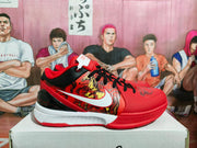 Side profile of a red basketball sneaker with patterned side panels, black heel detail, white midsole, and red outsole.