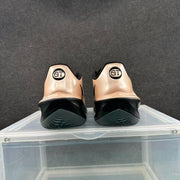 Rear view of the sneakers showing black heel details and circular GT markings.