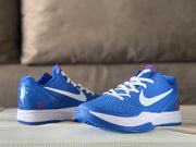 Pair of blue sneakers displayed from the side with white laces, white Swooshes, red number 8 details, and blue outsoles.
