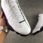 Top view of the laces and front of the white and purple sneaker