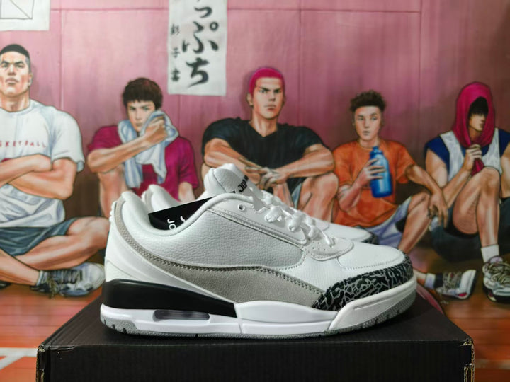 Side view of white and grey Jordan low-top sneakers with a patterned toe overlay and visible Air unit.