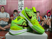 Angled view of the Nike sneakers showing black Swoosh logos, illustrated side graphics, dotted panels, and white midsoles.