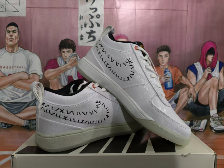 Pair of white Nike low-top sneakers displayed on a shoe box, showing black stitched side detailing and translucent-looking outsoles.