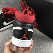 Close-up rear view showing the red collar, black heel panel, red Jumpman emblem, and red outsole.
